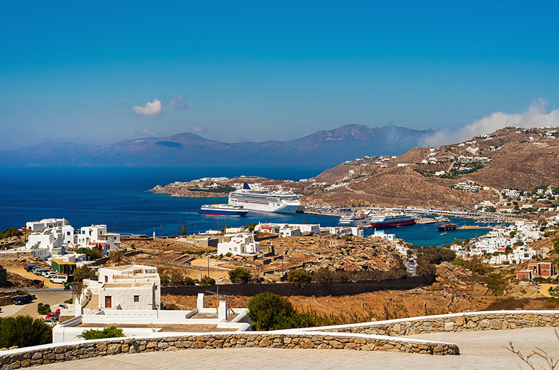 Cruise ship docking at Mykonos Port in Tourlos with marina and yachts in Mykonos Greece mykonos-new-port-tourlos-landscape-cruise-view
