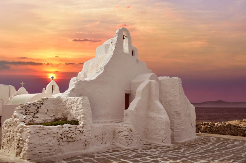 Paraportiani Mykonos church at sunset overlooking the Aegean Sea in Mykonos Greece 03-paraportiani-mykonos-church-sunset-aegean-view