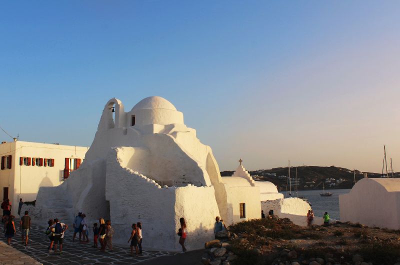 Visitors exploring Paraportiani Mykonos church in the Kastro area of Mykonos Town Greece 04-paraportiani-mykonos-church-visitors-kastro-area